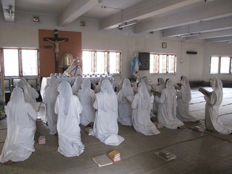 Sisters of Mother Teresa's Missionaries of Charity in prayer in the chapel of the Mother House, Kolkata, India at January 27, 2009