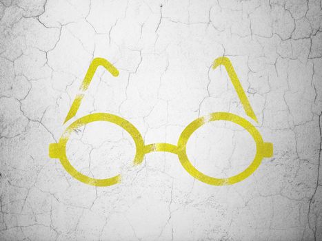 Science concept: Yellow Glasses on textured concrete wall background