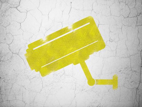 Privacy concept: Yellow Cctv Camera on textured concrete wall background