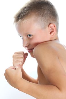 Serious and determined young boy wearing boxing gloves and looking at the camera. Isolated on white