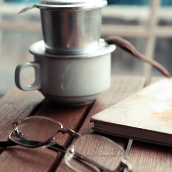 Coffee time in morning, relax moment in rainy day, coffee cup on cafe table with window background, slow life by enjoyment 