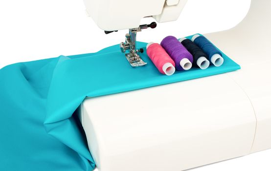 Close-up sewing machine and fabric on white background