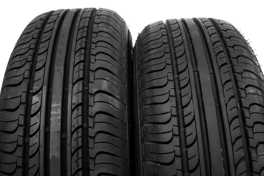 Two new car tires close up on white background