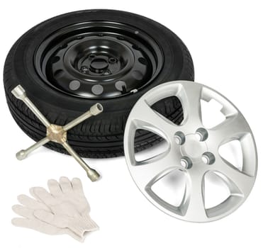Tyre with screwdriver, glove and wheel cap. Isolated