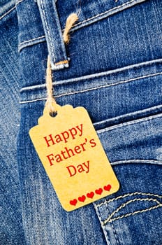 Happy fathers day sign in paper on blue denim jeans background.