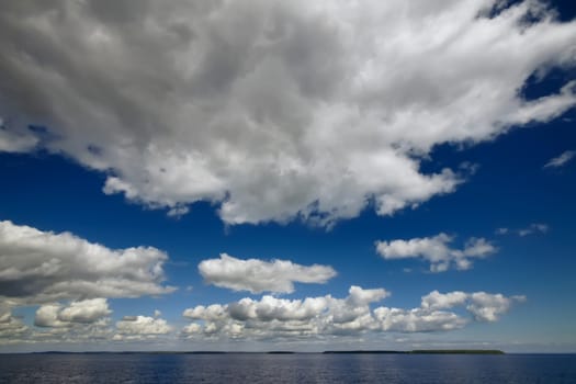 Blue sky with clouds over sea. Nature composition.