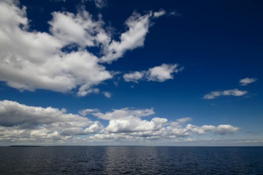 Blue sky with clouds over sea. Nature composition.