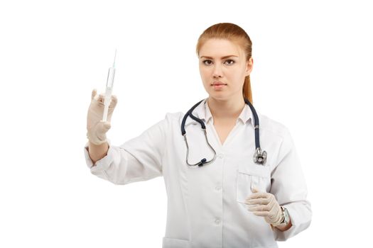 Portrait of an attractive young woman doctor with a syringe in her hand over white background