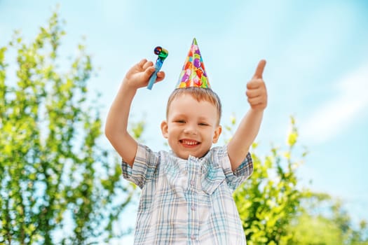 Little boy gesturing and having fun celebrating birthday. Positive emotions.