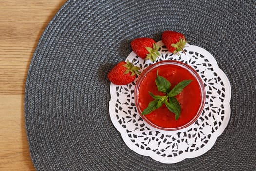 Fragrant strawberry jam with a sprig of mint