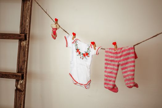 Things for the newborn girl hanging on rope