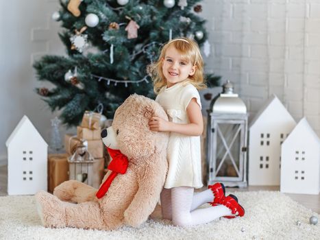 Beautiful Little girl waiting for a miracle in Christmas decorations