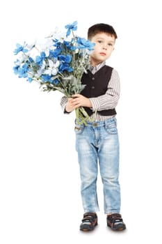 Funny little boy holding a large bouquet of flowers isolated on white background