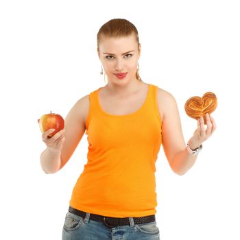 Young beautiful girl in thinking what to eat to lose weight - the apple or bun. Isolated on white background. Concept of healthy nutrition.