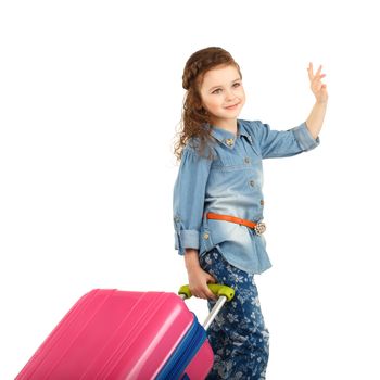 portrait of a pretty little girl with big pink suitcase on wheels isolated on white background. Concept holidays and vacations.