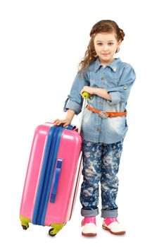 Full-length portrait of a pretty little girl with big pink suitcase on wheels isolated on white background. Concept holidays and vacations.