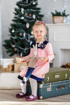 Beautiful Little girl waiting for a miracle in Christmas decorations