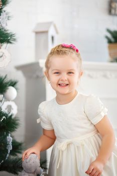 Beautiful Little girl waiting for a miracle in Christmas decorations