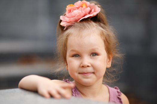 Close-up portrait of a lovely urban little girl outdoors