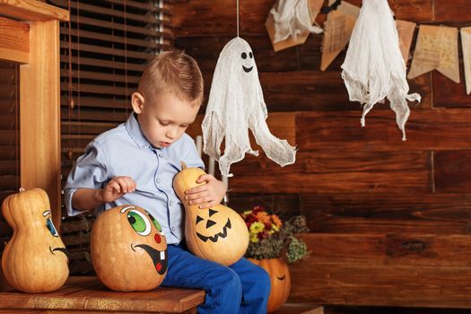 Adorable Cute Little Boy having fun in Halloween decorations