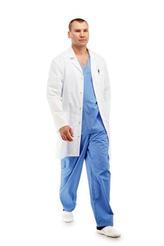 Full length portrait of a young male doctor in a medical surgical blue uniform in motion leaving the operating room against a white background