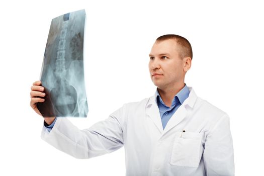 Portrait of a young male doctor in a white coat against a white background