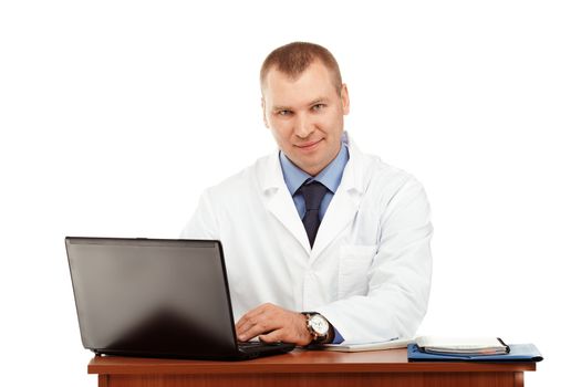 Portrait of a young male doctor in a white coat against a white background