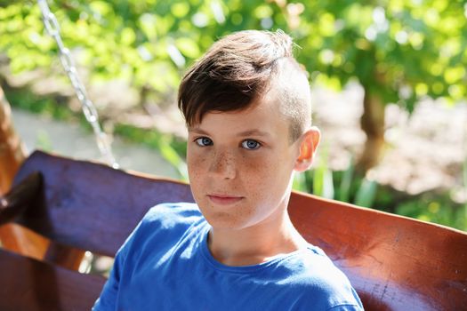 Close-up portrait of a handsome teen boy outdoors