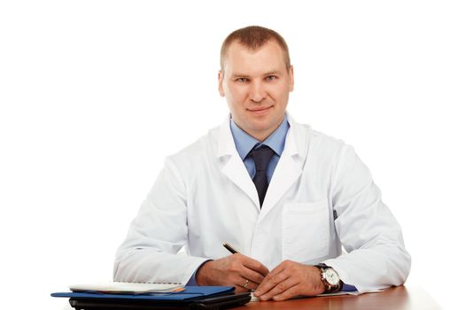 Portrait of a young male doctor in a white coat against a white background