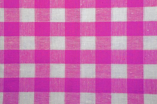 The texture of checkered fabric as a background. Checked fabric tablecloth. Fabric in a large square. Texture plaid fabric