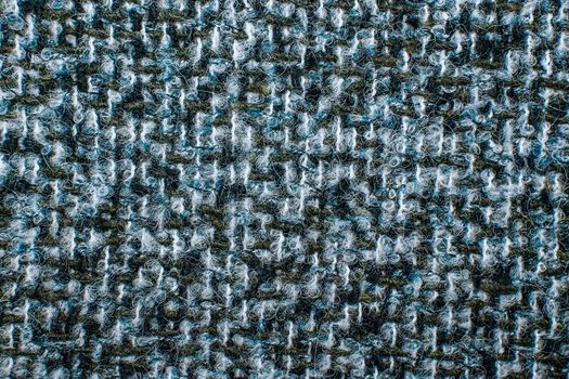 Varicolored tweed like texture, varicolored wool pattern, textured melange upholstery fabric background copy space. Background texture of twill