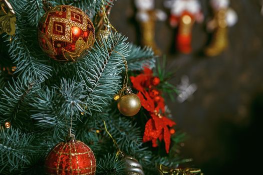 Decorated Christmas tree on blurred, sparkling and fairy background. Beautiful color christmas decorations hanging on christmas tree with shiny glare