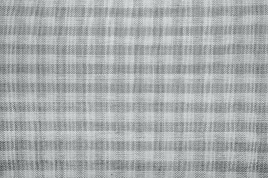 The texture of checkered fabric as a background. Checked fabric tablecloth. Fabric in a small square. Texture plaid fabric. Texture background of kitchen towels
