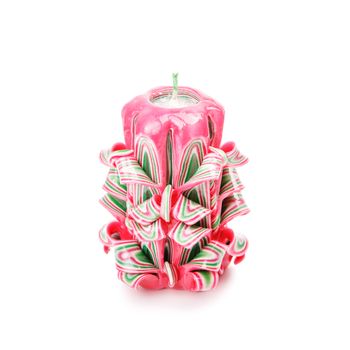 Carved colored candle isolated on white background