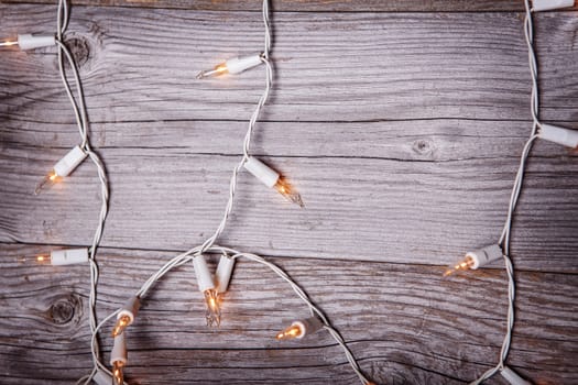Grunge plank wood texture background. Garland Lights Wood Background, Wooden Board Texture with Holiday Light garland