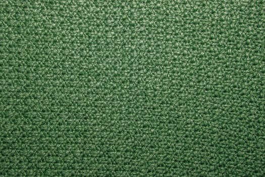 Seed stitch in green yarn as an abstract background texture