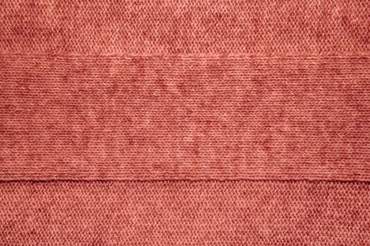 Wool sweater texture close up. Knitted jersey background with a relief pattern. Braids in machine knitting pattern