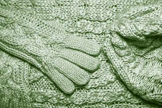 Set of Wool sweater or scarf, hat and gloves texture close up. Knitted jersey Fabric background with a relief pattern. Braids in machine knitting pattern. Wool hand-knitted or machine knitting pattern.