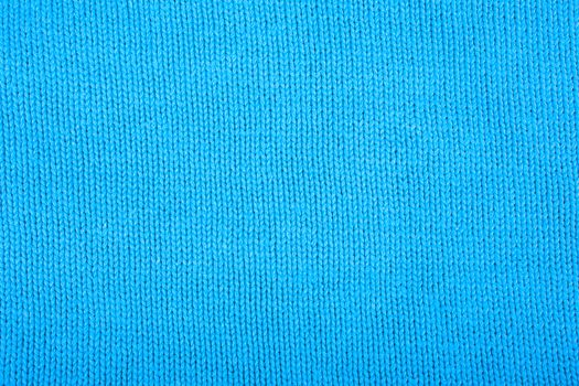 Wool sweater texture close up. Knitted jersey background with a relief pattern. Braids in machine knitting pattern