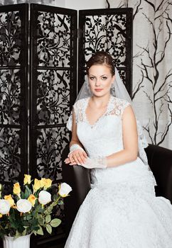 Young gorgeous bride. Beautiful and fashion bride in luxury interior. Beautiful and fashion bride with glamour makeup and hairstyle
