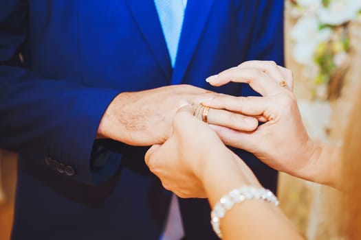 Wedding rings, engagement ring on the finger of the groom