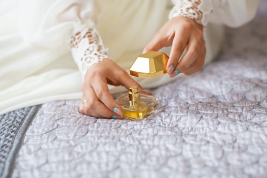 bride applying gentle perfume on her wrist. Bride reveals favorite perfume.