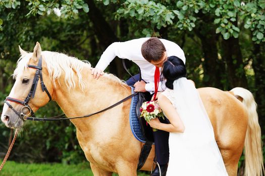 Wedding. Bride and groom with horse. bride and groom on a horses in the forest