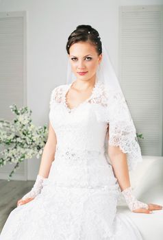 Young gorgeous bride. Beautiful and fashion bride in luxury interior. Beautiful and fashion bride with glamour makeup and hairstyle