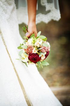 Beautiful wedding bouquet in hands of the bride