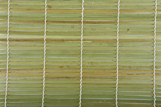 Texture from bamboo wooden background. Green Bamboo mat. Traditional green bamboo pad texture. sushi matt background abstract texture. Macro fragment of bamboo mat for making sushi