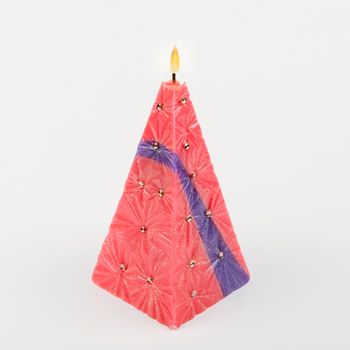 Decorative Handmade candle in the shape of a pyramid on white background