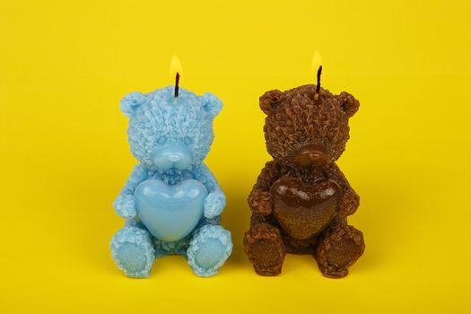 Colorful handmade candles in the shape of teddy-bear. Funny child candles. Souvenir gift candles. Light the candles. A burning candle. Candle lit. Candle Light