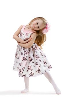 little girl in a dress dancing isolated on white background