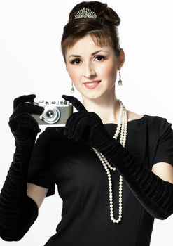 Portrait of a beautiful young elegant woman with a vintage camera isolated on white background